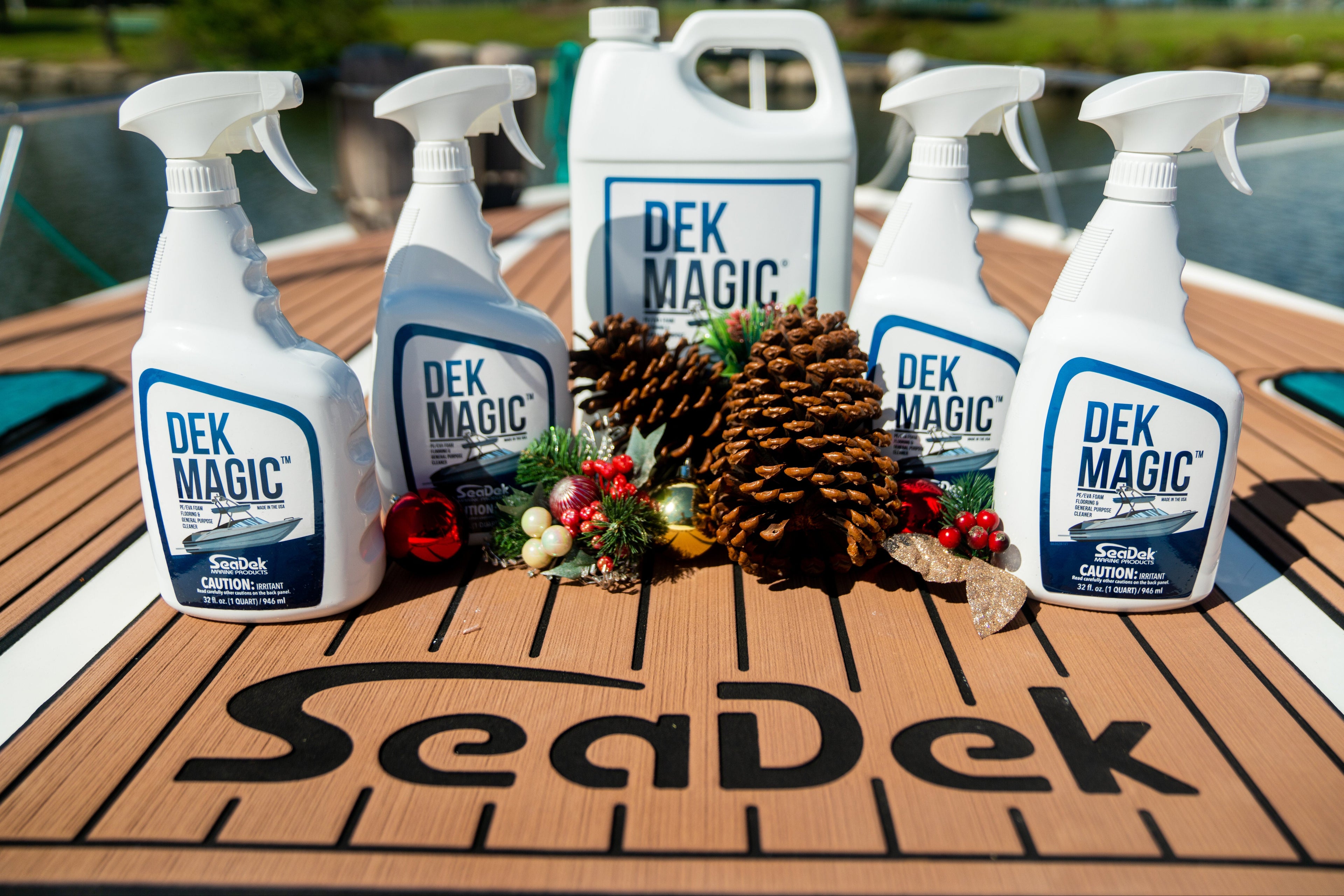 Spray bottles labeled 'DEK MAGIC' on a SeaDek surface with decorative elements.